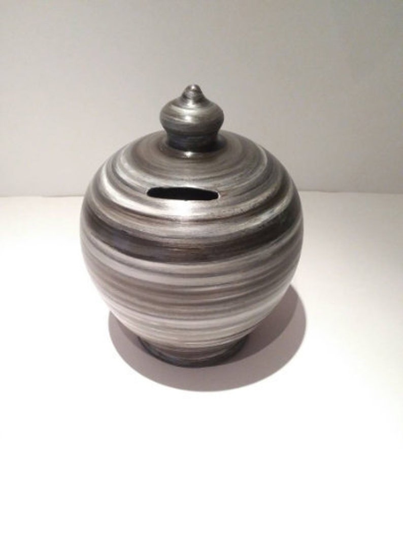 Handmade Italian pottery at its finest. Add character to your home and save money in style. Curvy, gorgeous, precious and one of the most classy and thoughtful gifts for a man or a woman. Handmade and hand painted in my studio in Rome, Italy.  Piggy bank size: 20 cm = 7.874 Inches. Circumference: 52 cm = 20 inch. Made to order. Colors: Silver, White and Black.  With hole and stopper plug, or without hole.