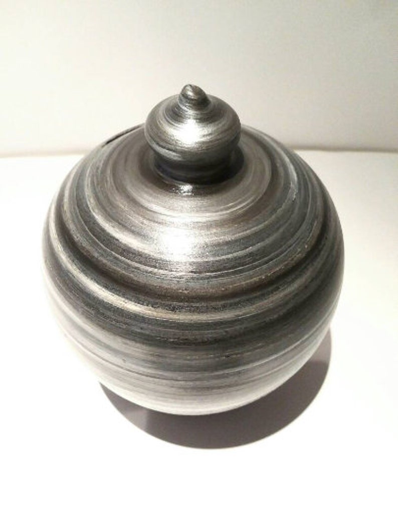 Handmade Italian pottery at its finest. Add character to your home and save money in style. Curvy, gorgeous, precious and one of the most classy and thoughtful gifts for a man or a woman. Handmade and hand painted in my studio in Rome, Italy.  Piggy bank size: 20 cm = 7.874 Inches. Circumference: 52 cm = 20 inch. Made to order. Colors: Silver, White and Black.  With hole and stopper plug, or without hole.